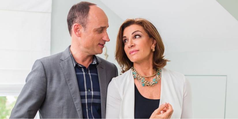 'Love It or List It' stars Hilary Farr and David Visentin stand close inside a house and look at each other.