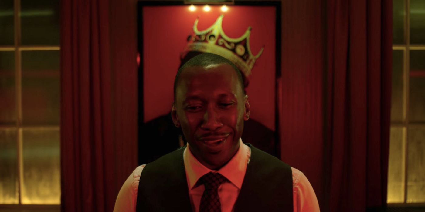 Mahershala Ali's Cottonmouth standing in front of a Basquiat with the crown of the photo over his head in Luke Cage