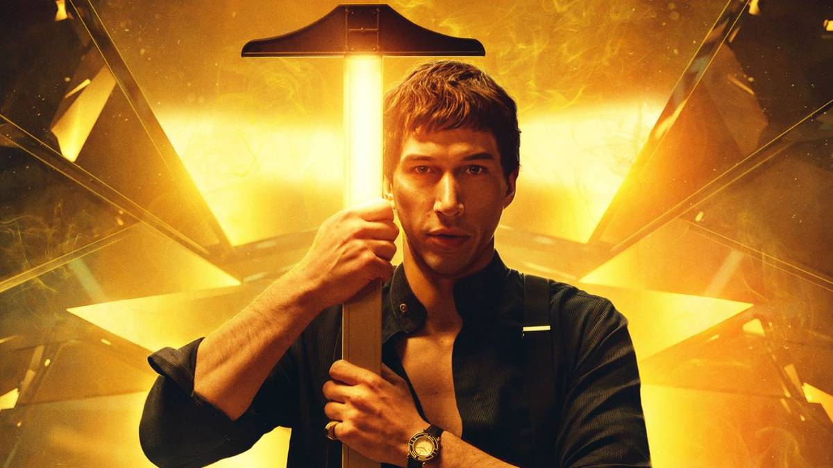 Adam Driver holding a pickaxe with a golden handle on the poster for Megalopolis.