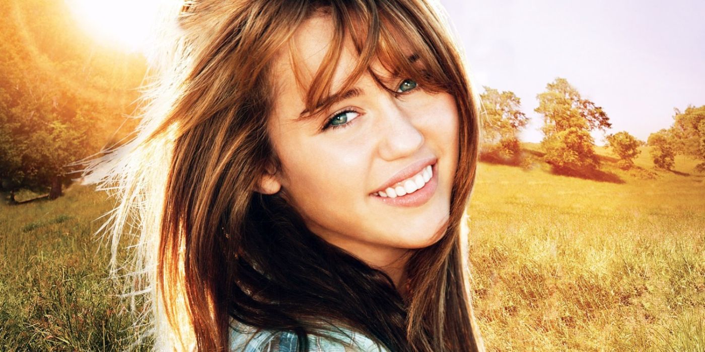 A cover shot of Miley Cyrus smiling with her hair blowing in the wind in 'Hannah Montana: The Movie'.