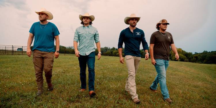 Steven McBee Jr, Cole McBee, Jesse McBee, and Brayden McBee walking in a field on 'The McBee Dynasty: American Cowboys'