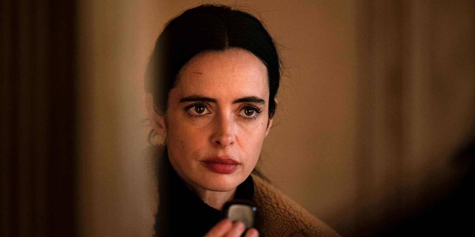 Krysten Ritter as Lucy looking serious in closeup in Orphan Black: Echoes