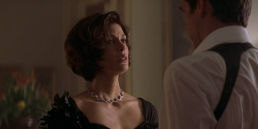 Paris (Teri Hatcher) in a black dress in 'Tomorrow Never Dies' (1)