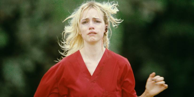 Willa Fitzgerald crying runs towards the camera in a red shirt in Strange Darling.