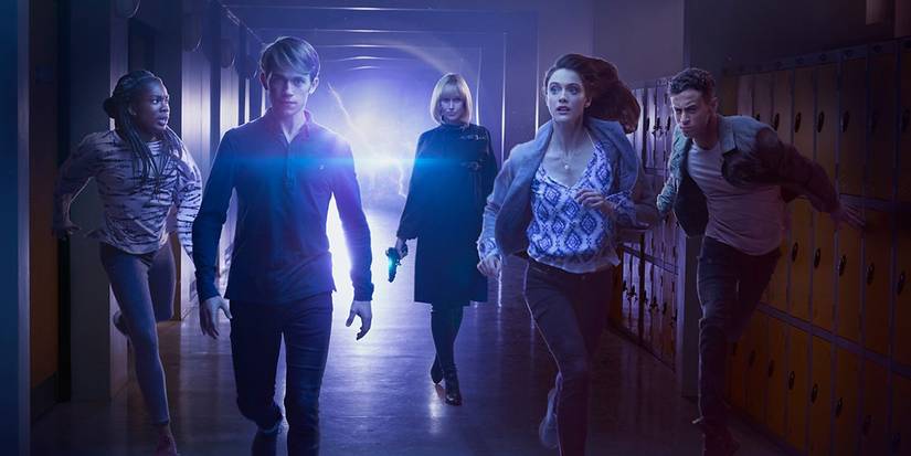 The cast of 'Class' in a poster running away from a mysterious light in a school hallway