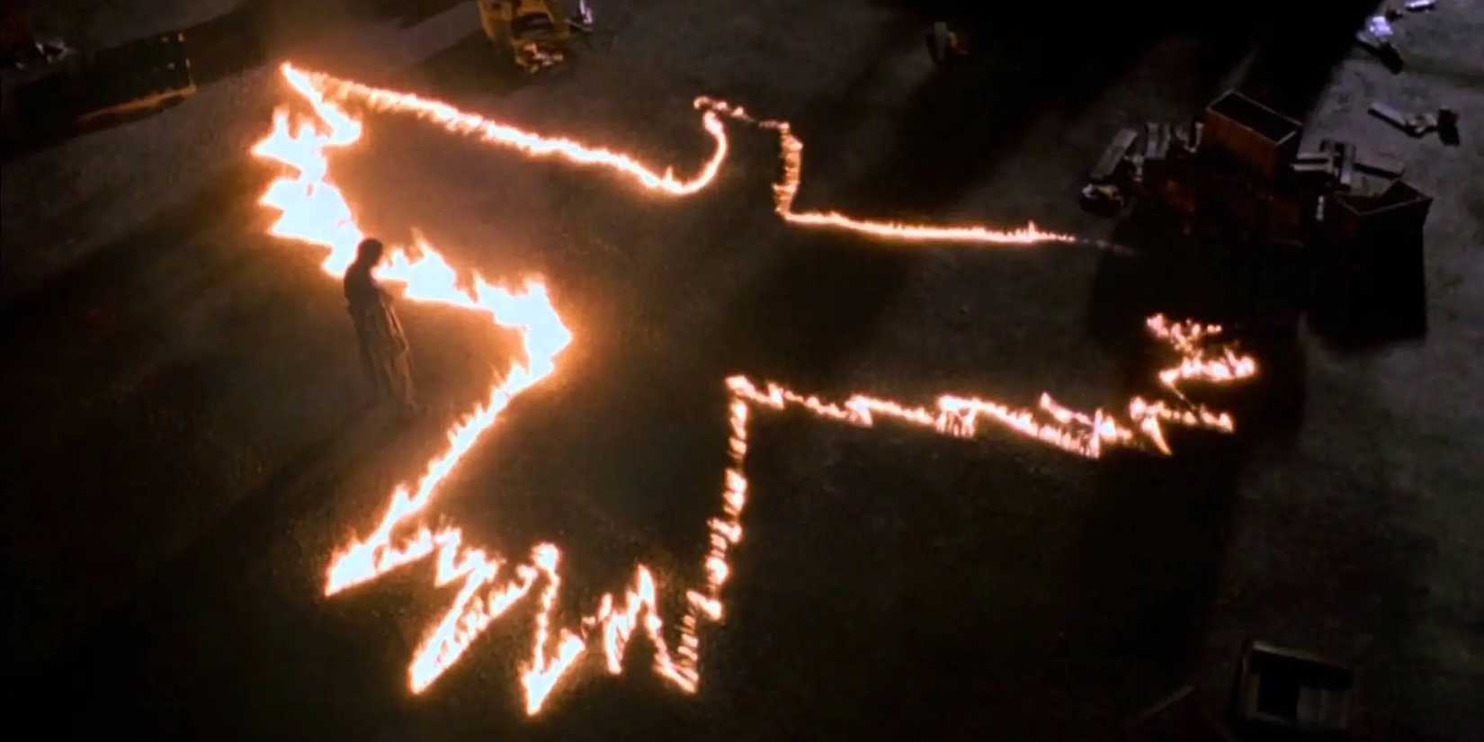 A fire silhouette of a crow in The Crow