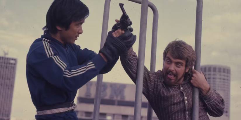 Two men fight over a gun in The Man From Hong Kong.