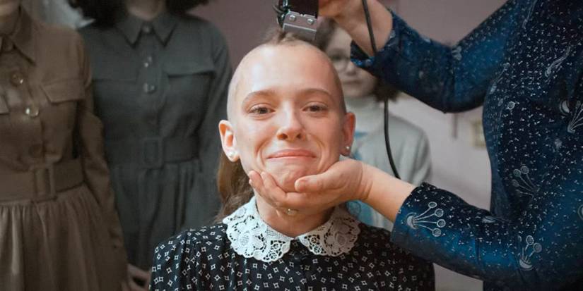 A young woman having her head shaved in Unorthodox