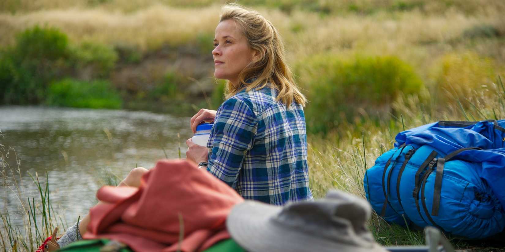 Reese Witherspoon as Cheryl Strayed in Wild sitting in the grass