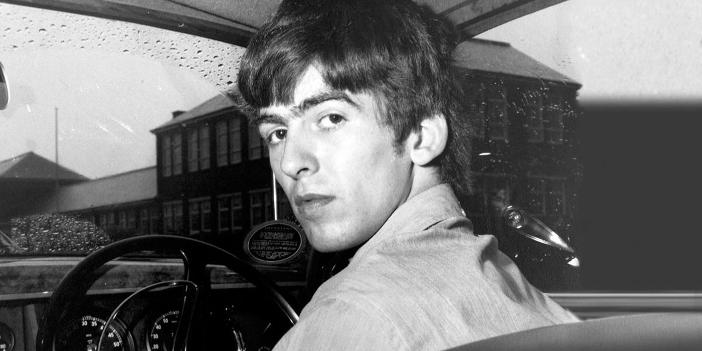 Young George Harrison in a car turning around to look at the camera in 'George Harrison Living in the Material World'