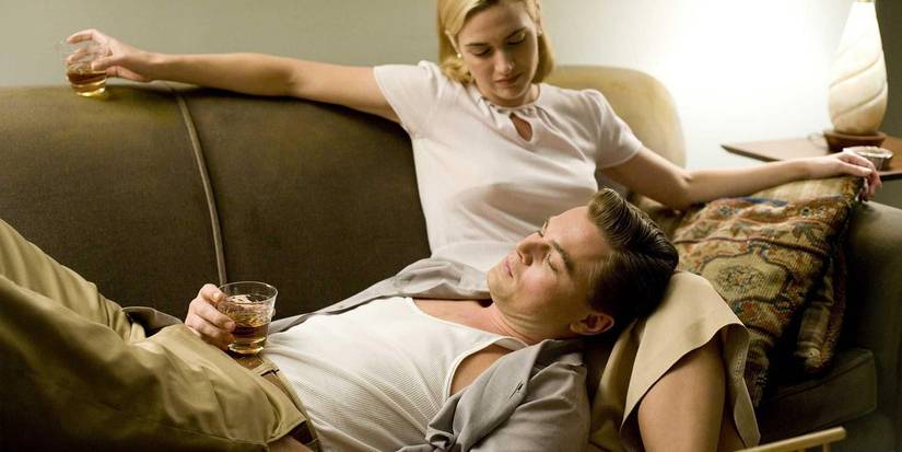Leonardo DiCaprio laying on Kate Winslet's lap on the couch in Revolutionary Road