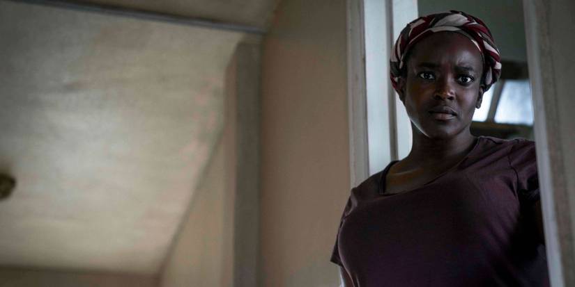 Rial Majur standing in a door frame looking intently in His House