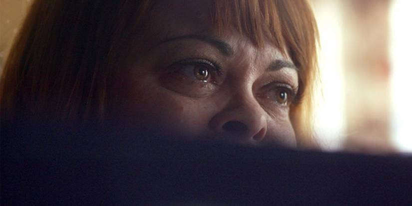 A close-up of a woman's eyes looking troubled while seeing a computer screen out of view in Don't F**k With Cats.