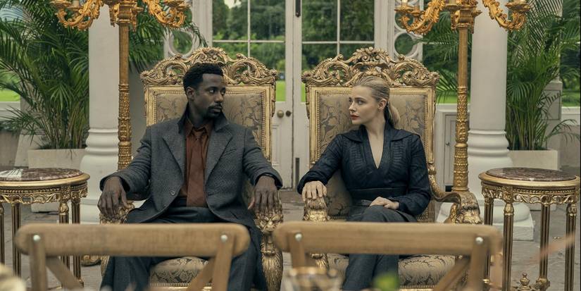 Flynne (Chloë Grace Moretz) and Wilf (Gary Carr) sit in ornate chairs in The Peripheral.