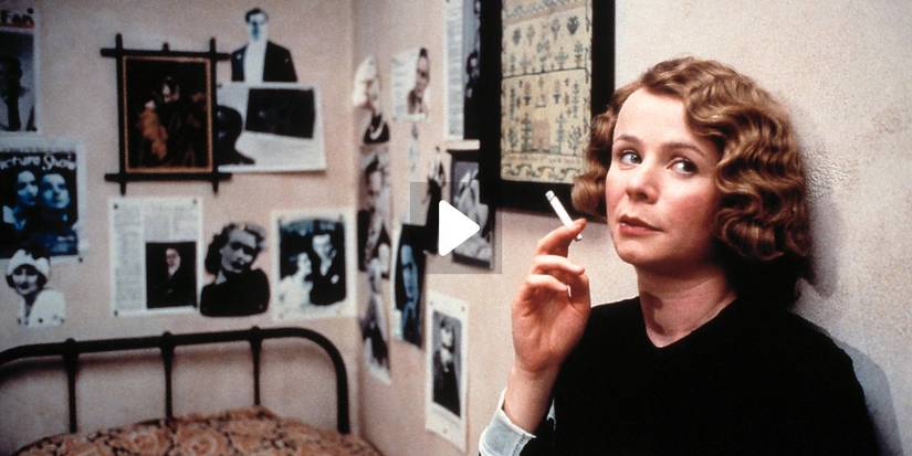 Emily Watson leaning against a wall and smoking in Gosford Park