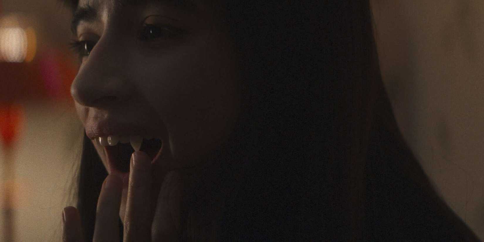Sasha inspecting her vampire fangs in Humanist Vampire Seeking Consenting Suicidal Person.