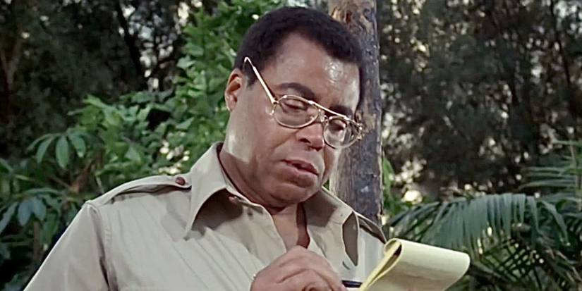 James Earl Jones writing on a pad of paper as Alex Haley in Roots: The Next Generations