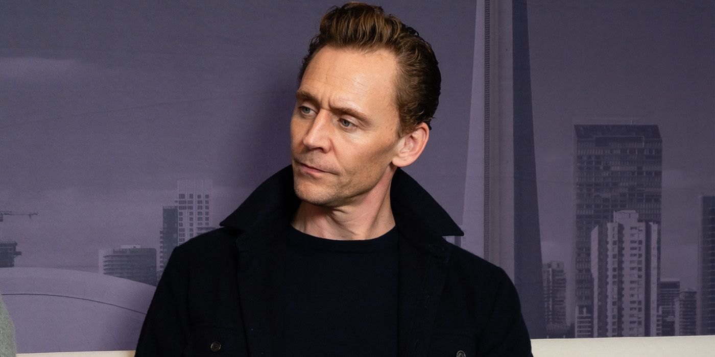 Tom Hiddleston listening with his head to the side in an interview at TIFF