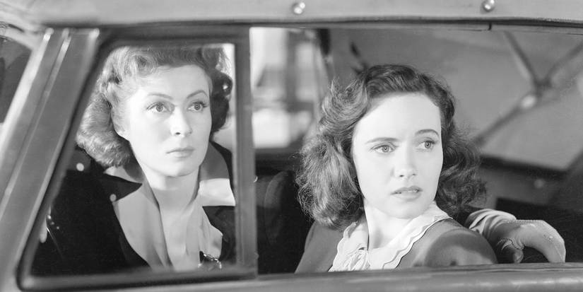 Greer Garson as Mrs. Miniver and Teresa Wright as Carol Beldon sitting in a car in Mrs. Miniver