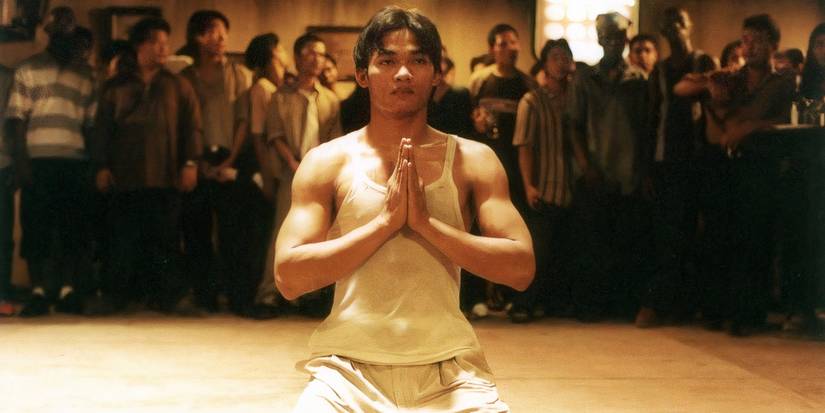 Tony Jaa kneeling with his hands clasped in 'Ong-Bak'