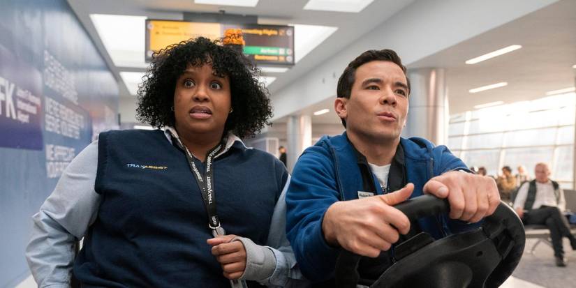 Natasha Rothwell and Conrad Ricamora ride in a cart in an airport in How to Die Alone.