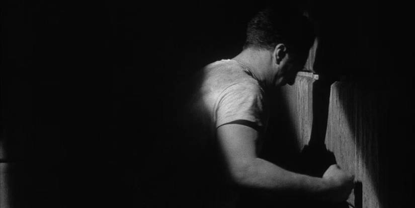 Locked in a cell, Jake LaMotta (Robert De Niro) punches the wall in 'Raging Bull' (1980).