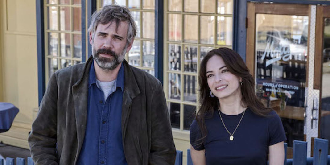 Rossif Sutherland and Kristin Kreuk standing next to each other in a scene from 'Murder in a Small Town'.