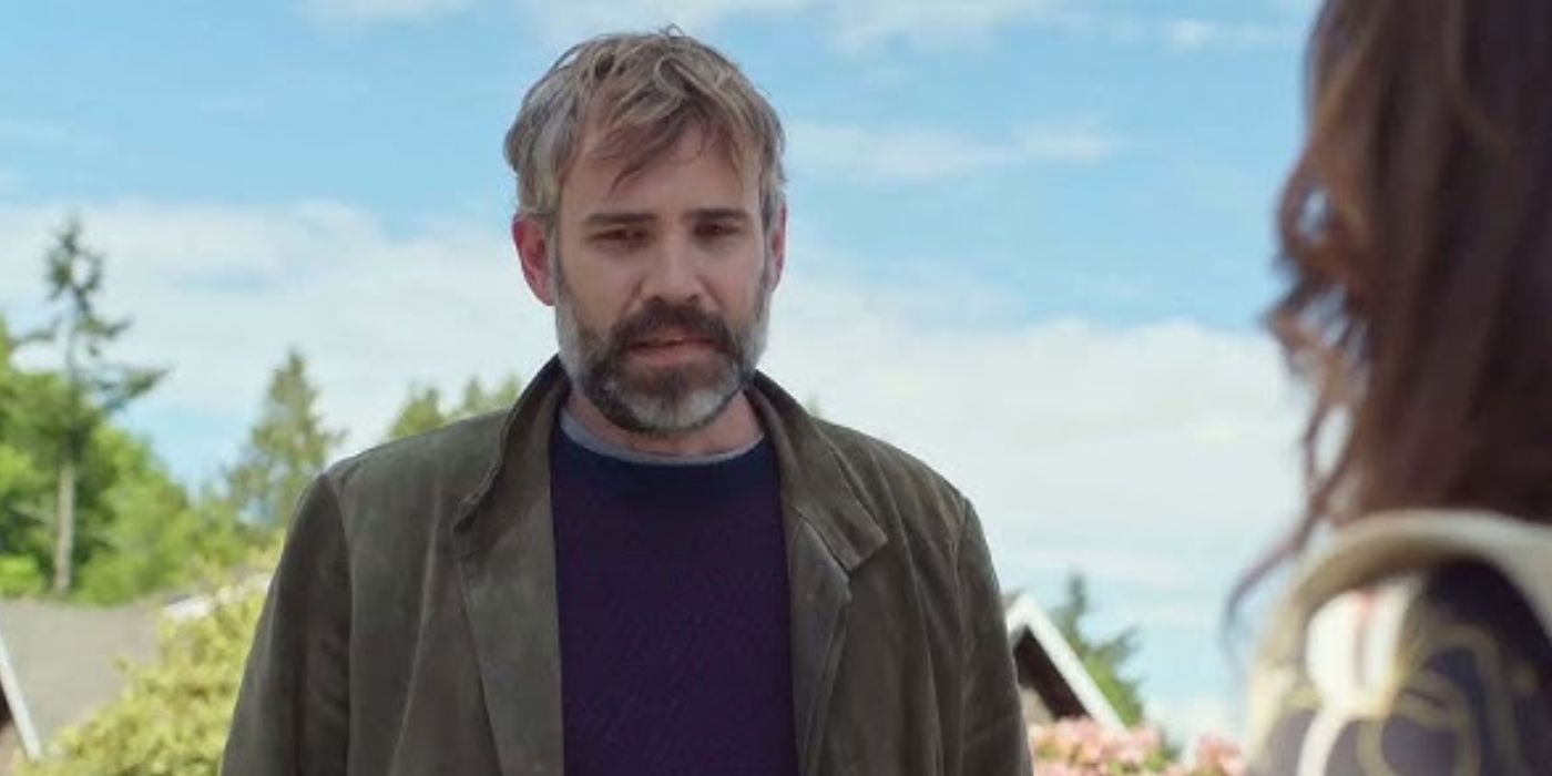 Rossif Sutherland looking at something with concerned expression in 'Murder in a Small Town'.