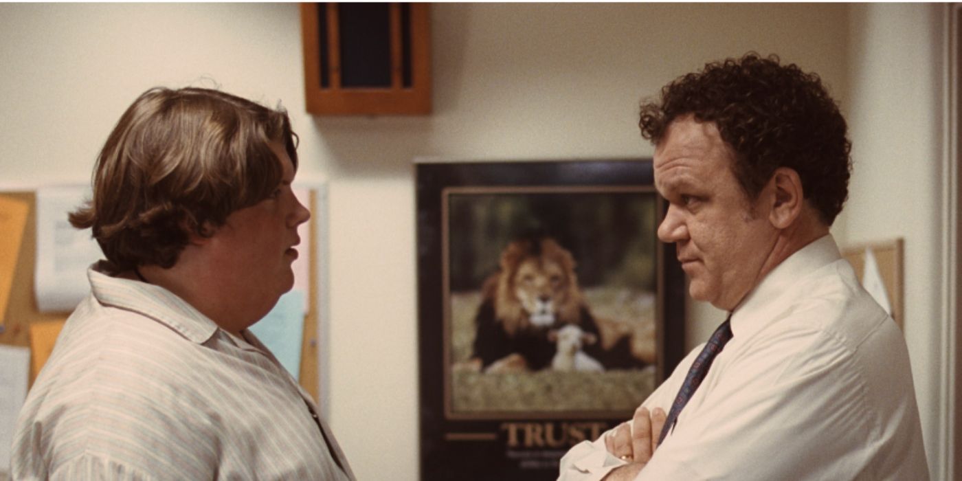 Jacob Wysocki and John C. Reilly and Terri and Mr. Fitzgerald talking to each other in the hallway in 'Terri'