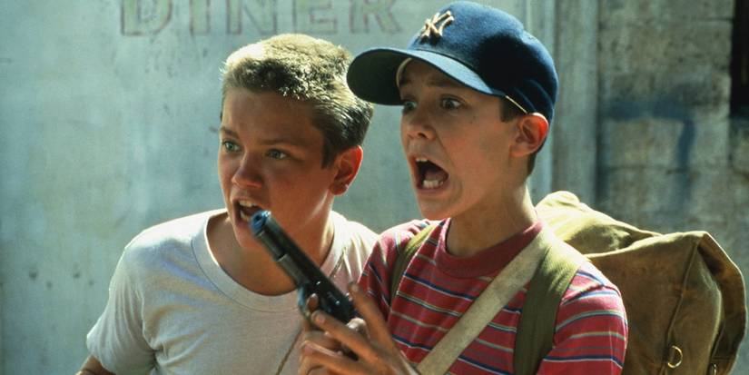 Chris and Gordie looking shocked with a gun in Stand by Me.