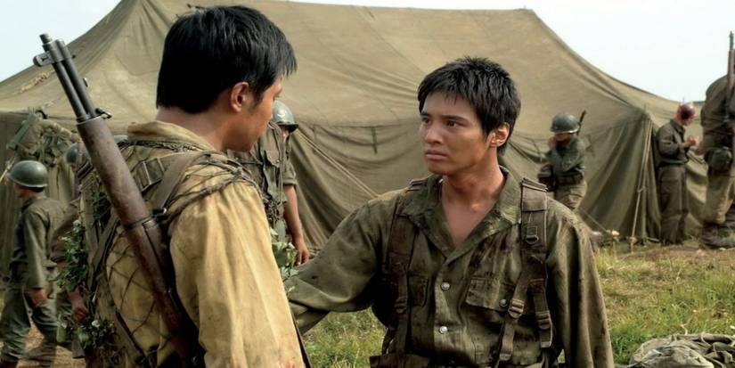 Two soldiers talking in a war camp filled with tents in The-Brotherhood-of-War