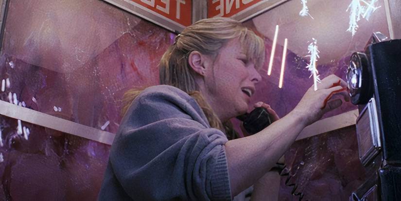 A woman is trapped in a phone booth surrounded by a pink monster in The Blob.