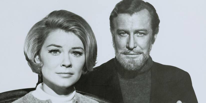 A black and white photo of a woman with short hair sitting, a man with a beard behind her in The Ghost and Mrs. Muir.