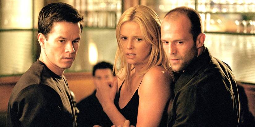 Mark Wahlberg, Charlize Theron, and Jason Statham standing together in The Italian Job.