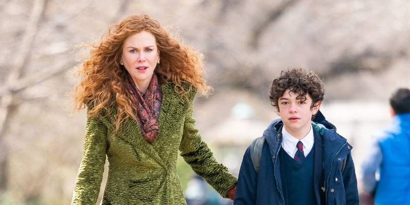 Grace (Nicole Kidman) in a bright green coat walks with Henry (Noah Jupe) in 'The Undoing.'