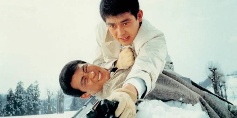 Two men fight in the snow and struggle over a weapon in Tokyo Difter.
