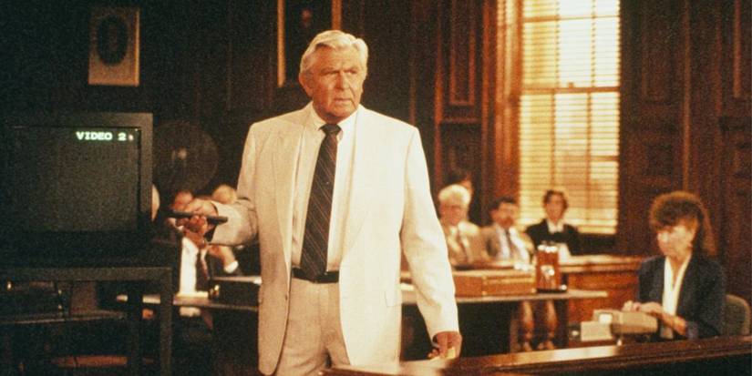 Andy Griffith wearing white suit and holding a remote control while in court in Matlock.