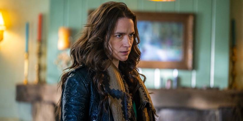 Melanie Scrofano as Wynonna Earp scowling in a living room in 'Wynonna Earp: Vengeance'