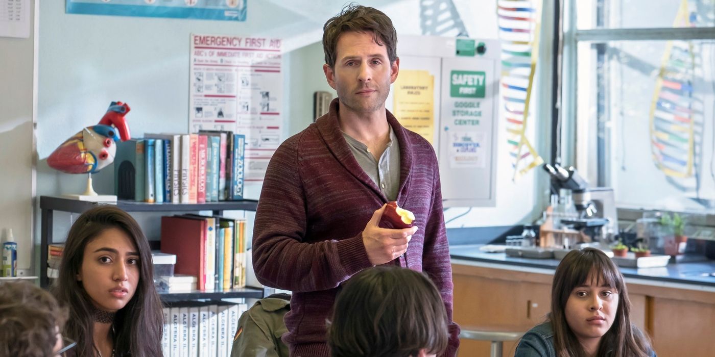 Jack (Glenn Howerton) stands with a half-eaten apple among his students in 'A.P. Bio.'