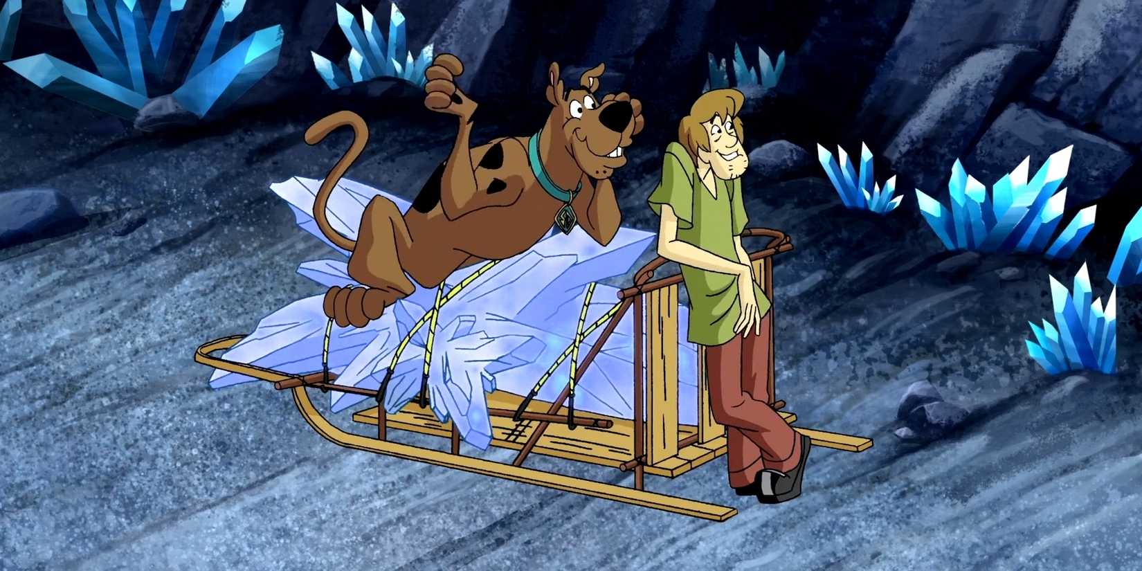 Shaggy and Scooby leaning on a wooden sled holding up a crystal in 'Chill Out, Scooby-Doo'