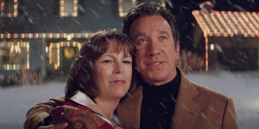 Tim Allen and Jamie Lee Curtis hugging in the snow in Christmas with the Kranks