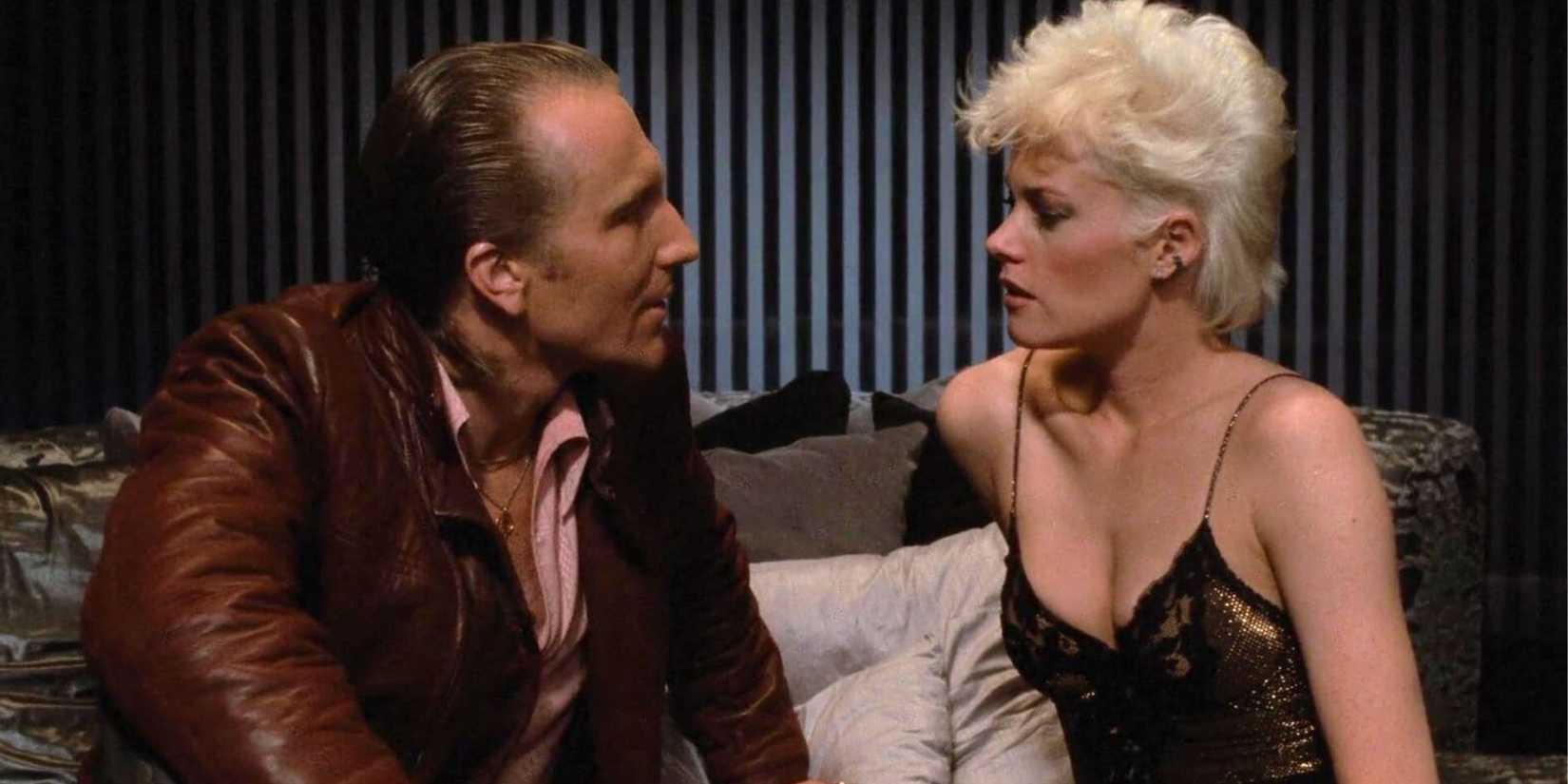 Craig Wasson sitting next to Melanie Griffith both looking at each other in Body Double (1984)