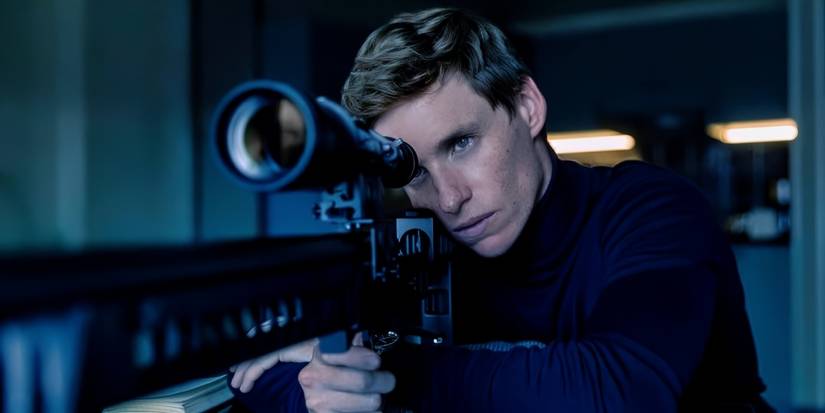 Eddie Redmayne staring down the scope of a sniper rifle in Day of the Jackal.