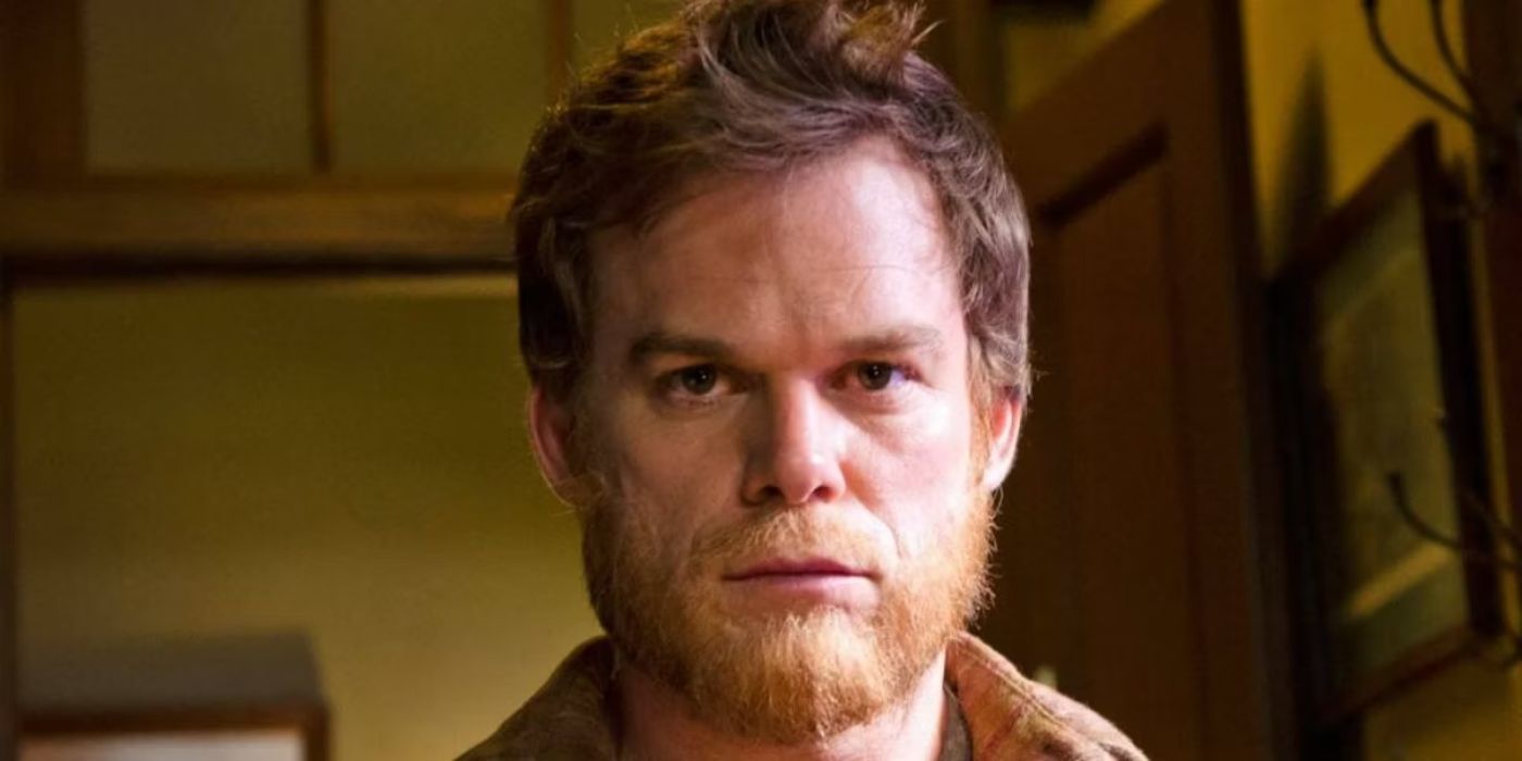 A closeup of Michael C. Hall as Dexter with shaggy hair and a beard looking blankly ahead in Dexter.