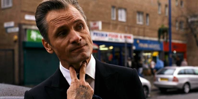 Viggo Mortensen as Nikolai Luzhin touching his throat in Eastern Promises
