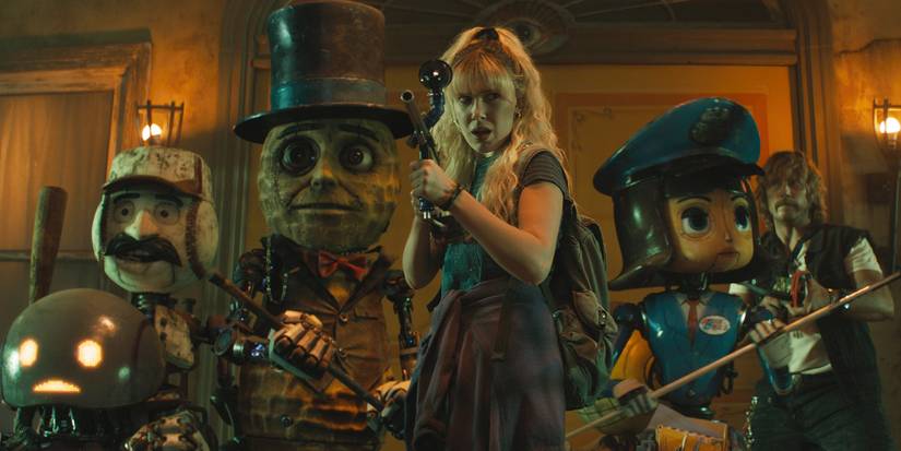 Millie Bobby Brown holding up a weapon and leading a group of robots and Chris Pratt in The Electric State