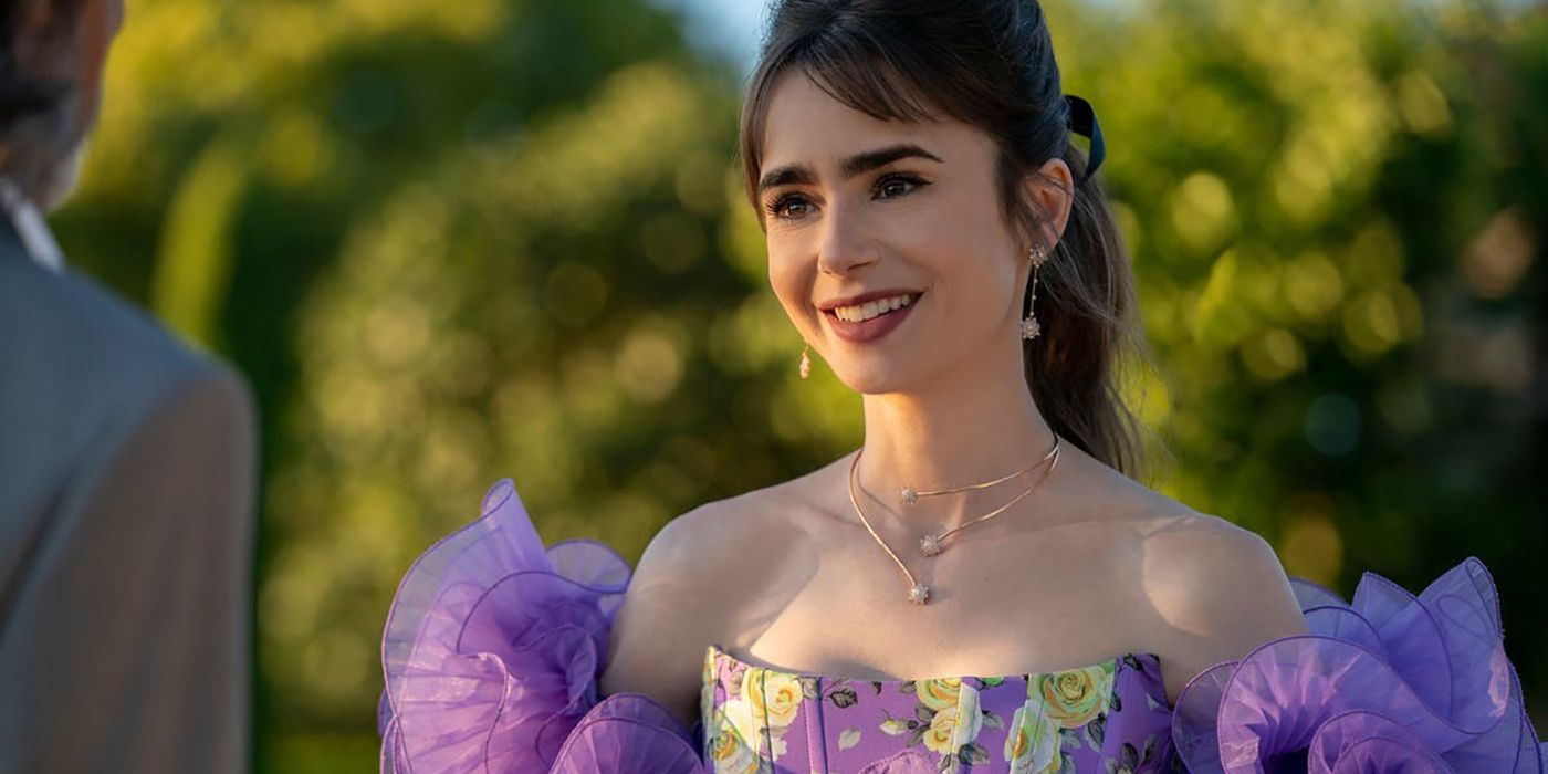 A close up of Emily smiling in Emily in Paris, wearing a purple puffy dress.