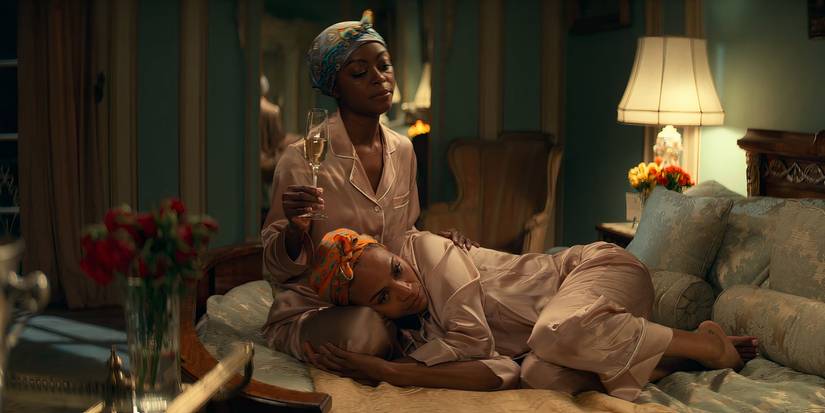 Zora (Danielle Deadwyler) comforts her sister Amy (Zoe Saldaña) on her bed in 'From Scratch'.