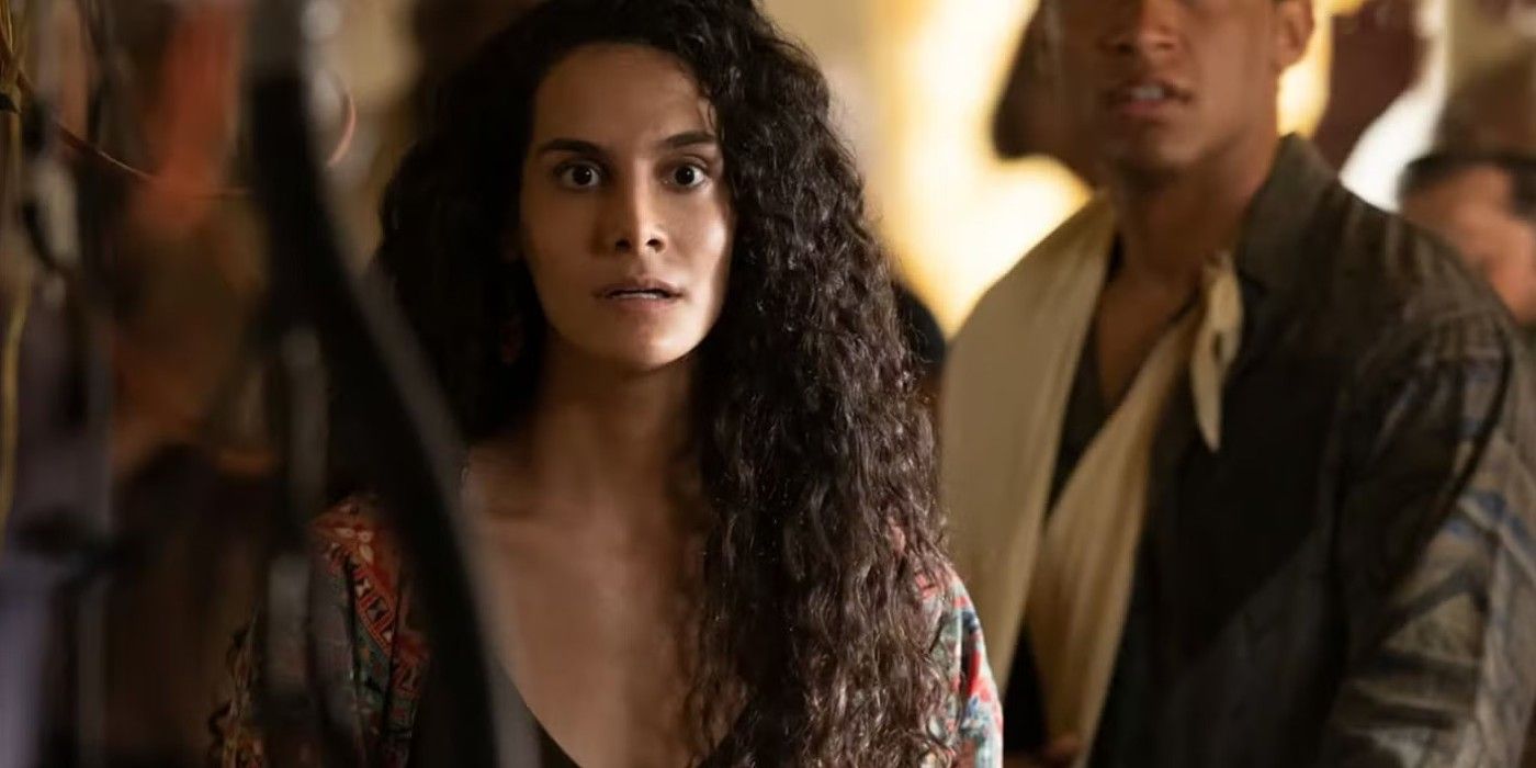 Fatima looking shocked with people behind her in the TV show From