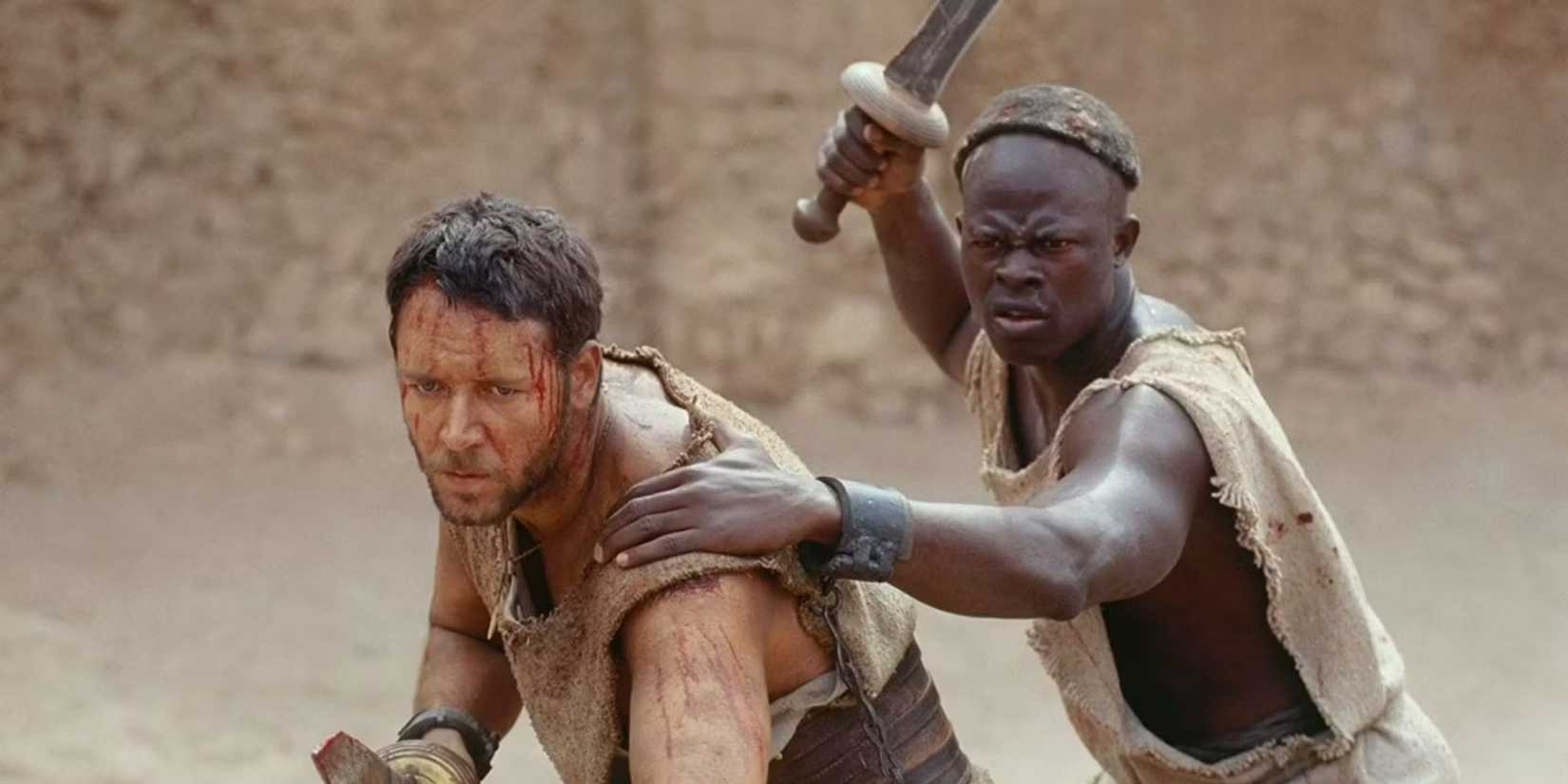 Maximus and Juba raising swords and getting ready to fight in Gladiator (2000)